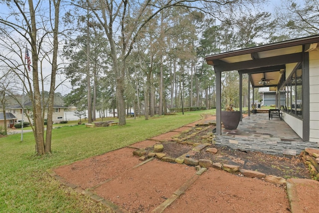 view of yard with a patio area and ceiling fan