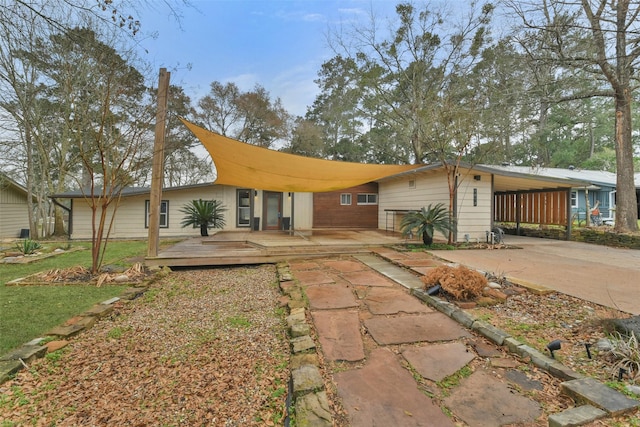 back of house featuring a carport