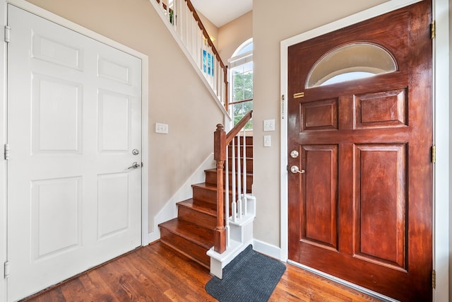 entryway with dark hardwood / wood-style flooring