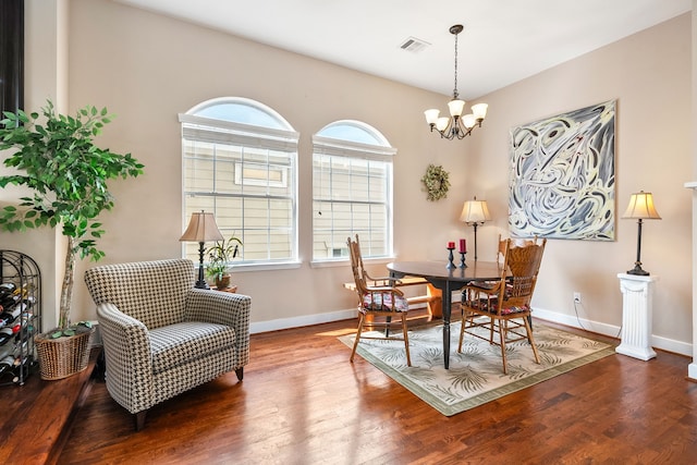 dining area featuring an inviting chandelier and dark hardwood / wood-style flooring