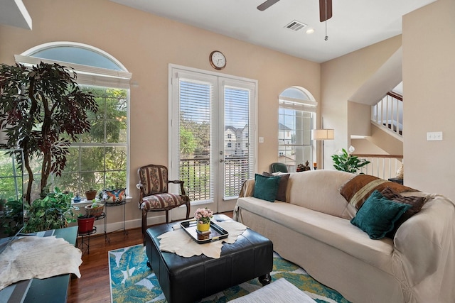 living room with ceiling fan, dark hardwood / wood-style flooring, and french doors