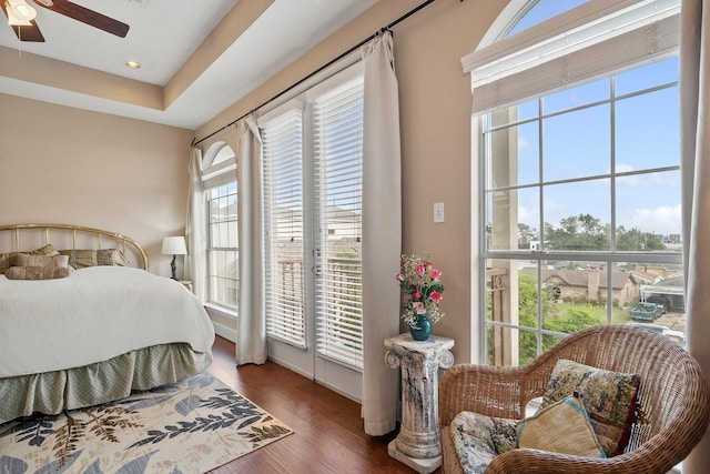 bedroom featuring dark wood-type flooring, ceiling fan, and access to outside