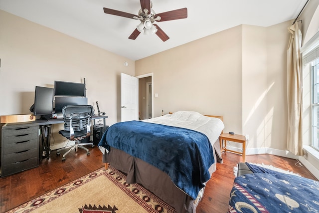 bedroom with hardwood / wood-style flooring, ceiling fan, and multiple windows