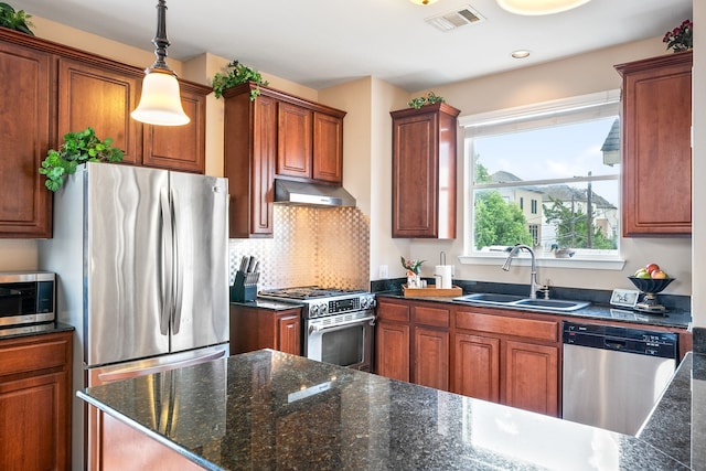 kitchen with hanging light fixtures, tasteful backsplash, appliances with stainless steel finishes, and sink