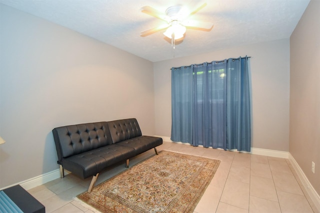 sitting room with light tile patterned floors and ceiling fan