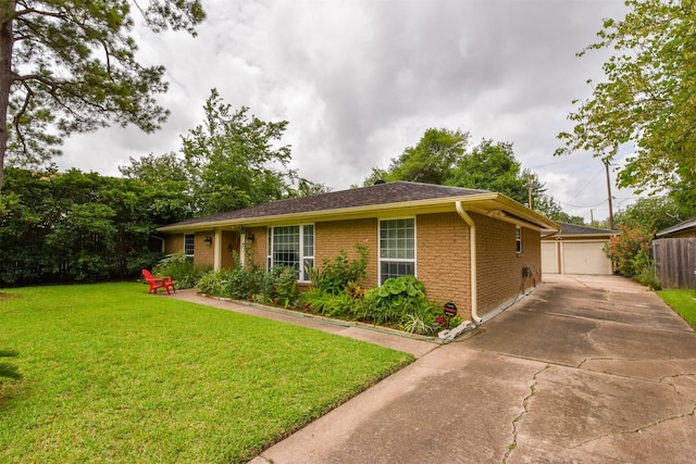 single story home featuring a garage, an outdoor structure, and a front lawn