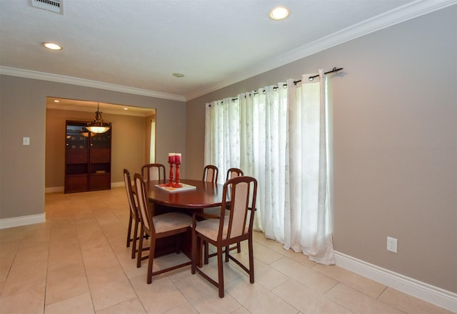 dining area featuring crown molding and light tile patterned flooring