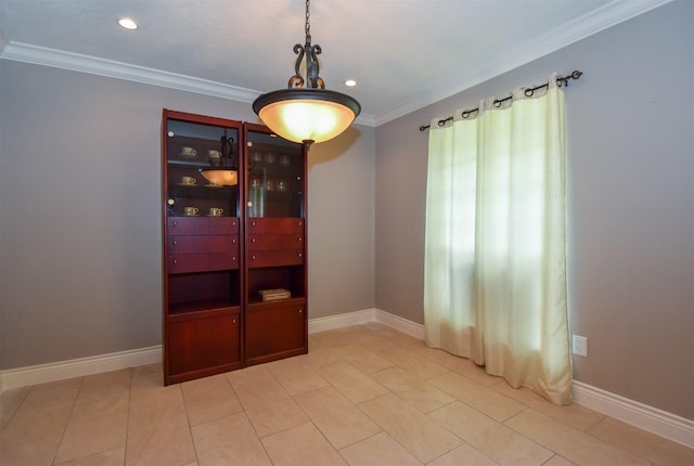 dining space featuring light tile patterned flooring and ornamental molding