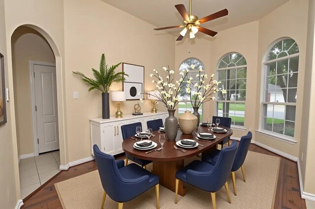 9210 Hidden Lake E Lake E, Magnolia, TX 77354 - dining room featuring arched walkways, a healthy amount of sunlight, ceiling fan, and wood finished floors