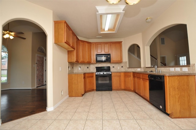 9210 Hidden Lake E Lake E, Magnolia, TX 77354 - kitchen with tasteful backsplash, black appliances, visible vents, light countertops, and a ceiling fan