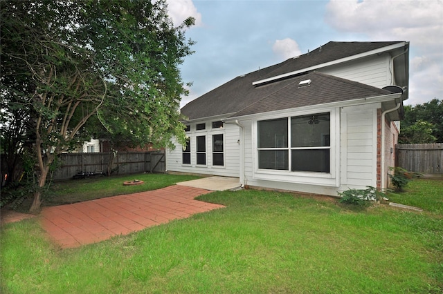 9210 Hidden Lake E Lake E, Magnolia, TX 77354 - back of property with a yard, a shingled roof, and a fenced backyard