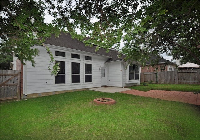 9210 Hidden Lake E Lake E, Magnolia, TX 77354 - back of property with a patio, a lawn, and a fenced backyard