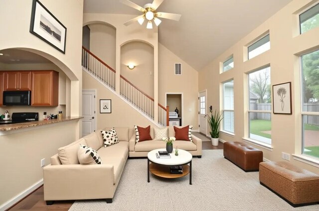 9210 Hidden Lake E Lake E, Magnolia, TX 77354 - living room with wood finished floors, high vaulted ceiling, visible vents, stairway, and a ceiling fan