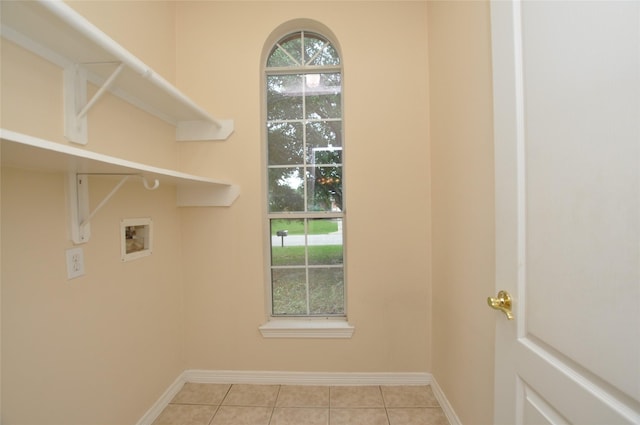 9210 Hidden Lake E Lake E, Magnolia, TX 77354 - laundry room with light tile patterned floors, hookup for a washing machine, laundry area, and baseboards