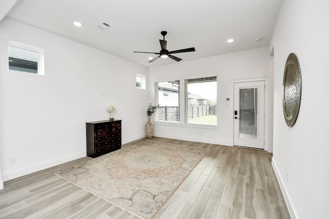 interior space with ceiling fan and light hardwood / wood-style flooring