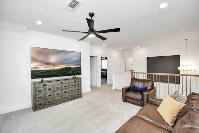 carpeted living room featuring a chandelier