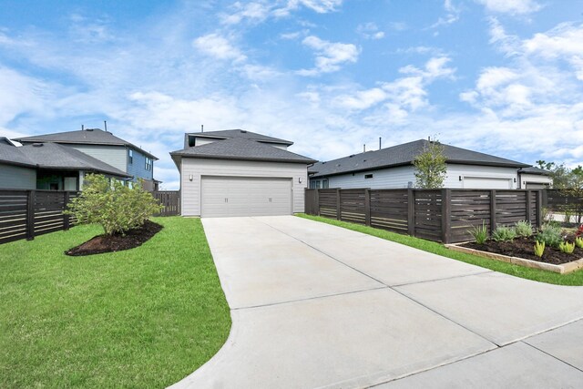 view of front of home with a garage and a front yard