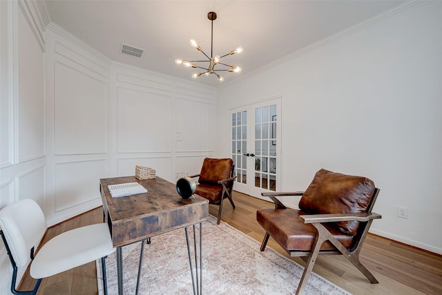 home office with french doors, ornamental molding, hardwood / wood-style floors, and a notable chandelier