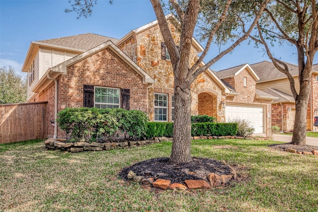 view of front property featuring a garage and a front yard