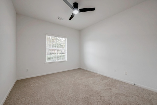 carpeted spare room with ceiling fan