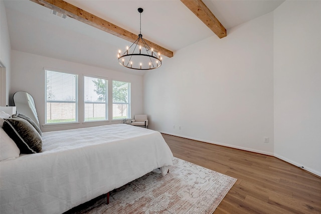 bedroom featuring beam ceiling, a chandelier, and hardwood / wood-style floors