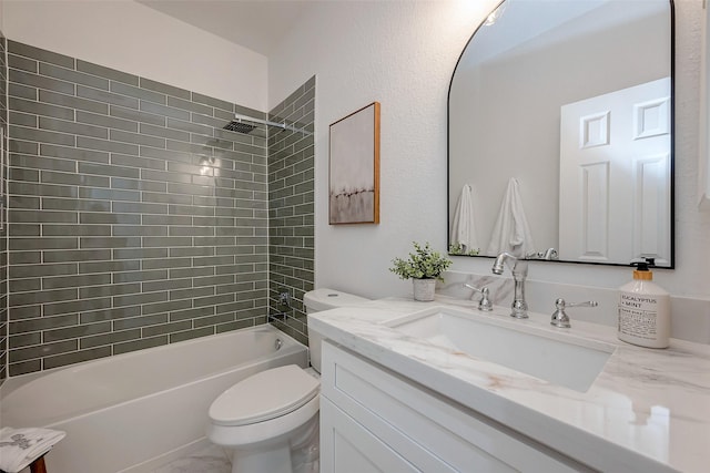 full bathroom with vanity, tiled shower / bath combo, and toilet