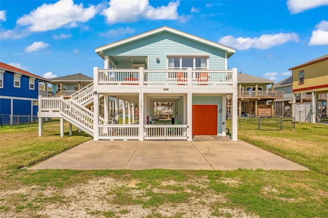 view of front of house featuring driveway, stairs, a carport, and a front yard