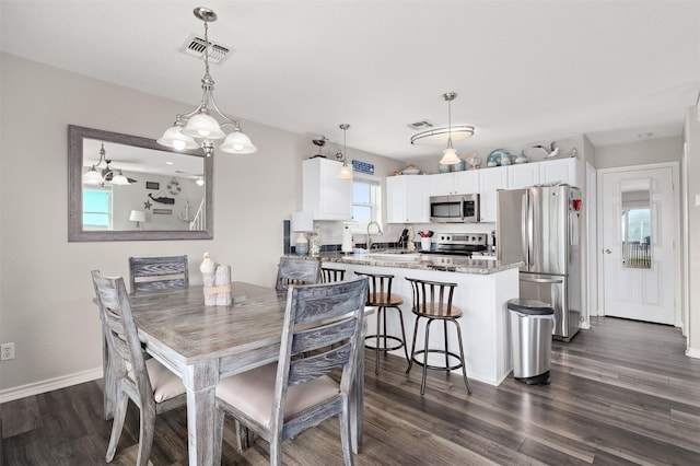 dining room featuring dark hardwood / wood-style floors and sink