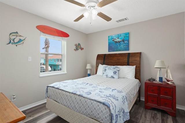 bedroom with ceiling fan and dark hardwood / wood-style flooring