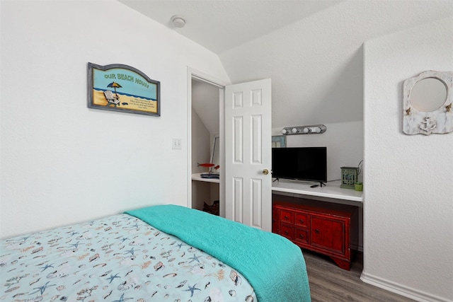 bedroom featuring dark wood-type flooring and vaulted ceiling