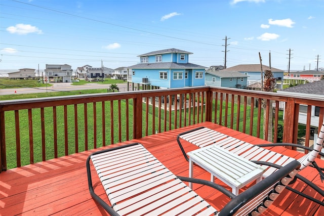 wooden terrace featuring a yard