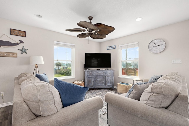 living room with wood-type flooring, plenty of natural light, and ceiling fan