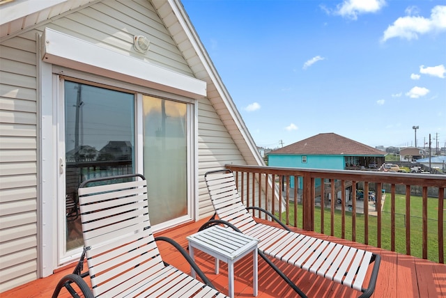 wooden deck with a lawn