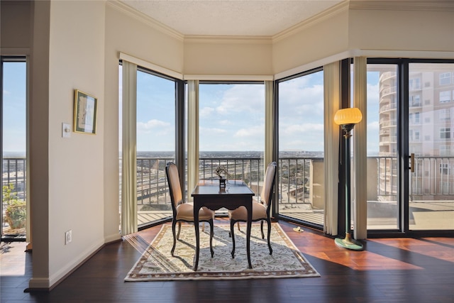 dining area featuring ornamental molding, plenty of natural light, dark hardwood / wood-style floors, and a textured ceiling