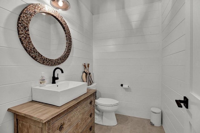 bathroom featuring vanity, tile patterned floors, and toilet