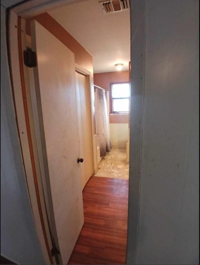 corridor with hardwood / wood-style floors