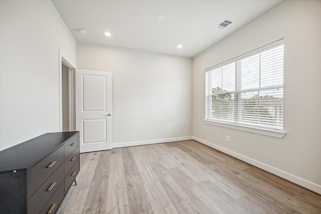 empty room with light hardwood / wood-style flooring