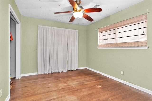 spare room featuring hardwood / wood-style flooring and ceiling fan