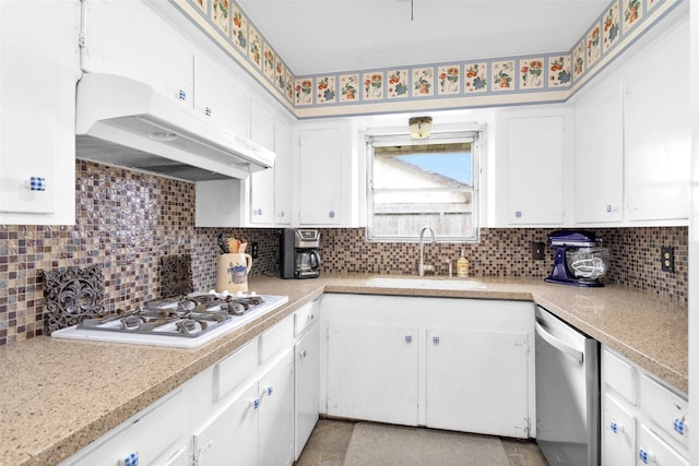 kitchen featuring sink, gas cooktop, dishwasher, white cabinetry, and tasteful backsplash