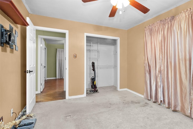 unfurnished bedroom with light colored carpet, a closet, and ceiling fan