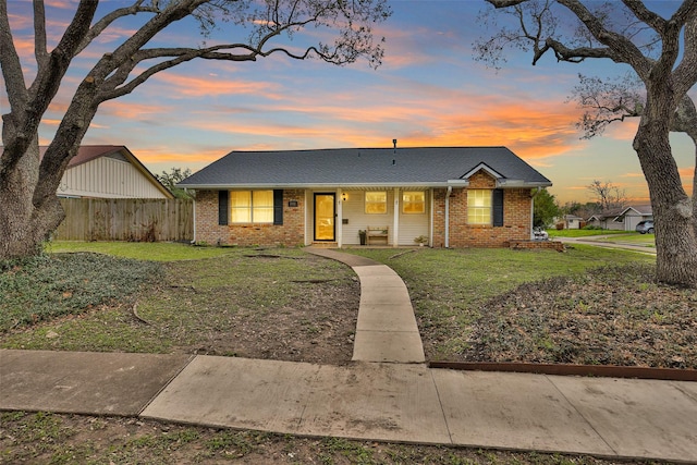 ranch-style home featuring a yard