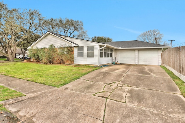 ranch-style home featuring a garage and a front lawn