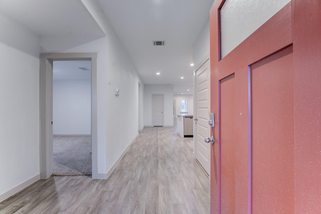 corridor with light hardwood / wood-style flooring