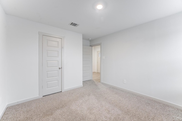 unfurnished bedroom with light colored carpet