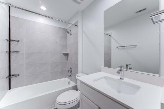 full bathroom with vanity, toilet, and tiled shower / bath combo