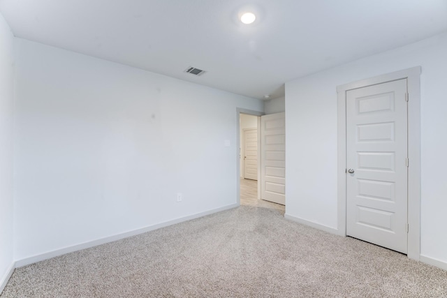 unfurnished bedroom with light colored carpet