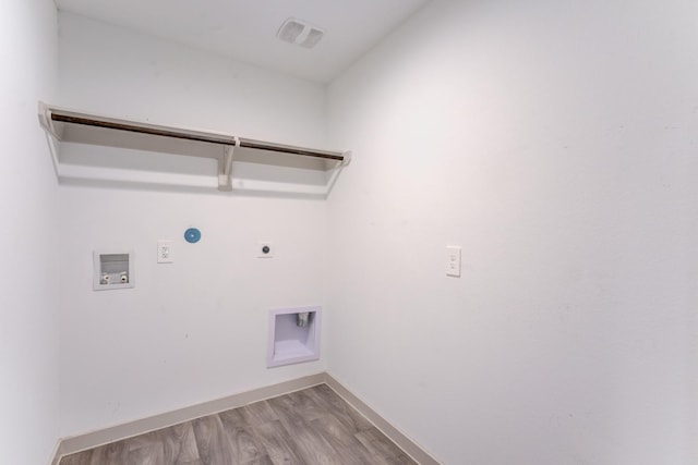 laundry area featuring hookup for a gas dryer, washer hookup, hookup for an electric dryer, and light hardwood / wood-style flooring