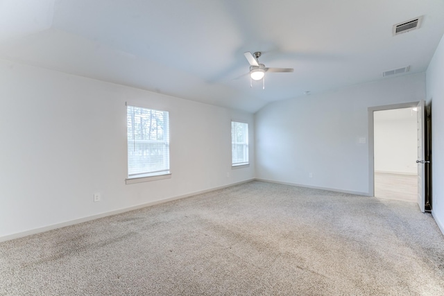 carpeted spare room with vaulted ceiling and ceiling fan