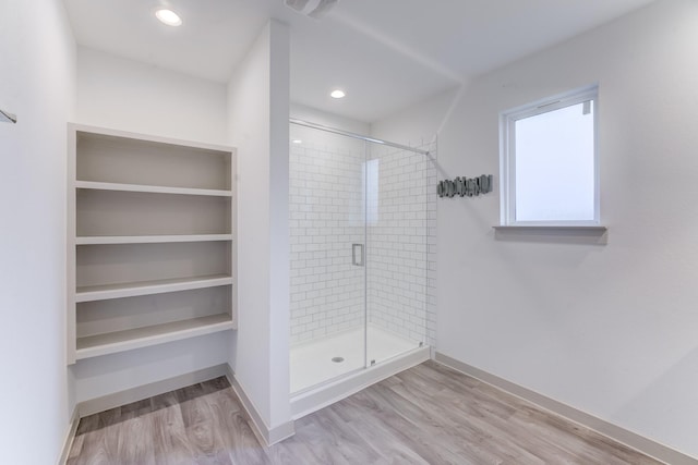 bathroom featuring hardwood / wood-style flooring and an enclosed shower