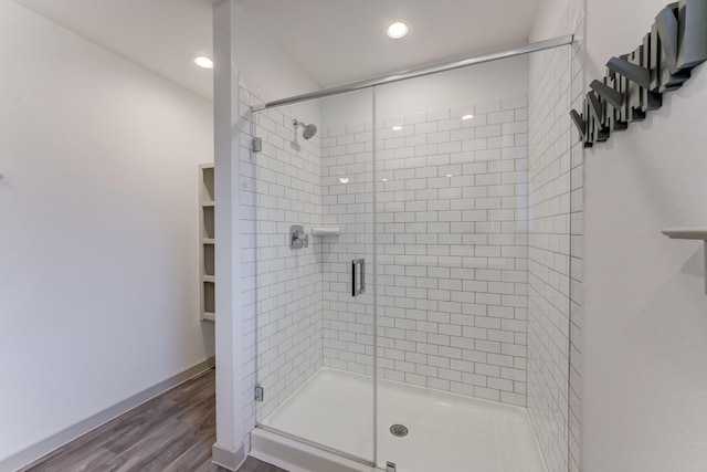 bathroom with walk in shower and hardwood / wood-style floors